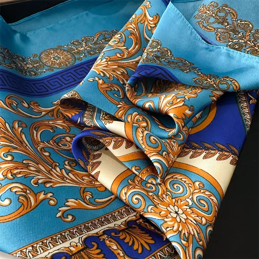 Elegant Foulard di Seta "Bandana Miami" with intricate blue and gold patterns, 70x70 cm available in diverse colors.